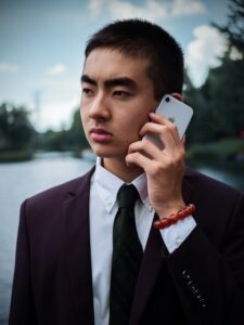 Man In Suit Outdoors Speaking On Cell Phone