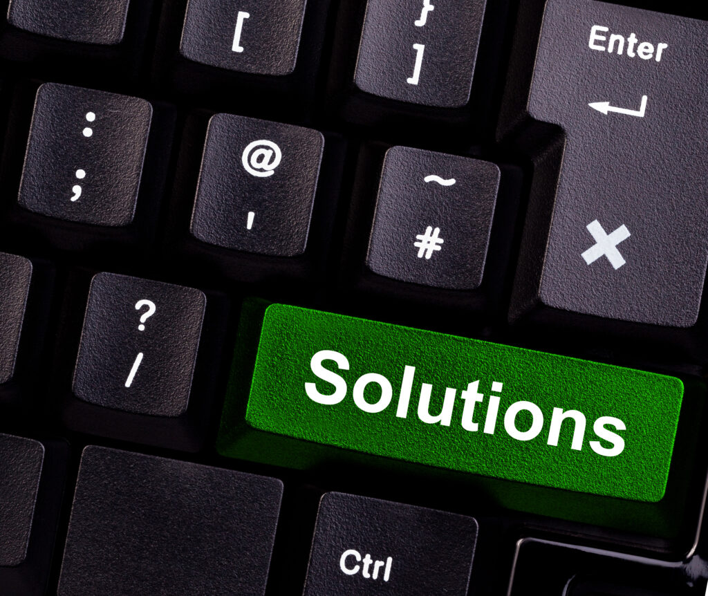 Computer Keyboard with the word "solutions" in green representing IT solutions