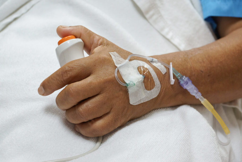 Patient's thumb on nurse call button