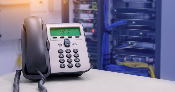 Phone in front of telephone system to represent business telephone questions